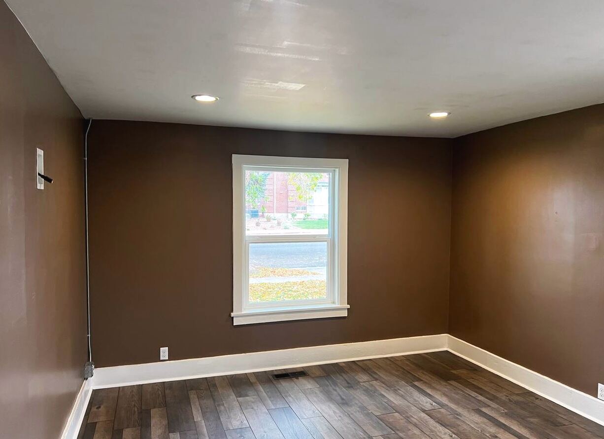 Private room with a street-facing window, recessed lighting and wide-plank flooring